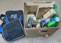 Duffle bag and open box showing mixed items