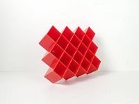 Front angled view of red honeycomb spice rack showing diamond grid structure