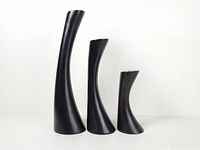 Front view of three graduated curved sonokwood candle holders