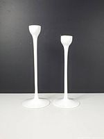 Front view showing both candlestick holders side by side displaying height difference and overall design