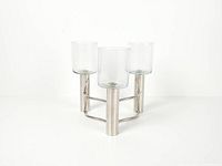 front view of chrome candelabra with three glass hurricanes