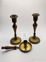 Front view of entire set showing two candlesticks and chamberstick with handle