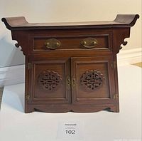 front view showing entire cabinet, brass hardware, carved panels
