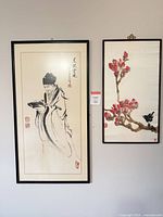 Both framed artworks hanging side by side