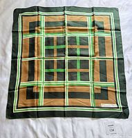 Full view of square silk scarf showing geometric design and colors