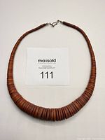 Full view of necklace laid flat showing graduated beads and clasp
