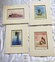 All four matted prints laid out showing artwork and mats