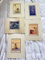 Overview of all five matted prints on white surface