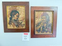 Both framed portraits side by side on wall with lot number visible