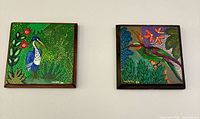 Both framed paintings side by side