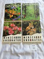 Four German nature/wildlife books laid out showing covers
