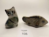 Front view of owl and fish figurines