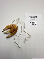 Full view of necklace with three claws and cord
