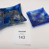 Both cobalt blue dishes side by side with lot number tag visible