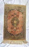 Full view of rug showing overall design, colors, fringe