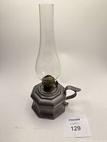 Full view of pewter oil lamp with chimney and handle