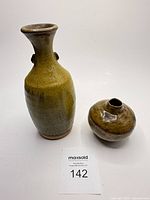 Both vases upright showing shapes and glaze