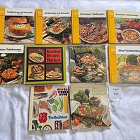 All ten cookbooks laid out, front covers visible