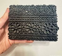 Front of carved wood printing block showing floral and geometric pattern