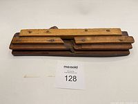 Top view of wooden molding plane showing fence and screws