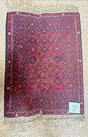 Full view of rug showing pattern, colors and fringe