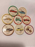 Fronts of eight Jell-O automobile tokens