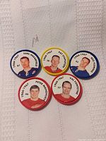 Front view of all five hockey coin discs