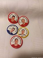 Five NHL hockey coins laid out showing player images and coloured rims