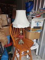 Full view of lamp on chair showing height, shade, base and cord