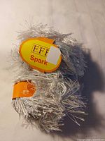 Two balls of silver Effe Spark yarn with labels
