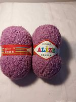 Two lavender Alize Mohair Boucle yarn balls with labels