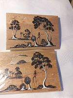 Front view of both paper bark postcards displaying painted scenes