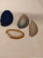 Four polished agate slices on cloth background