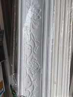 Close-up of raised floral design on white moulding