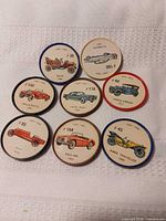 Obverse side of seven wheels showing car illustrations