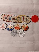Assorted hockey coins, car wheels, Post tokens spread on cloth