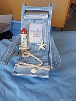 Front view showing decorative beach chair photo holder with lighthouse, starfish and rope details
