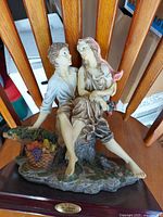Full view of Capodimonte figurine on wood base