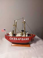 Portside view of red Chesapeake model boat on stand