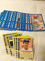 Stacked view of multiple blue-border 1991 Score rookie cards with Tim McIntosh card front visible
