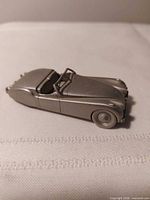 Left side view of pewter Jaguar model showing overall form