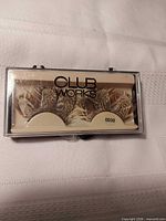 Front view of Club Works feather eyelashes in sealed case