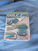 Front of boxed Garlic Pro dicer showing product image and features