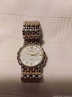 Front view of Geneva two-tone wrist watch showing dial and bracelet