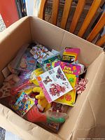 Overview of box with assorted toys and party favors
