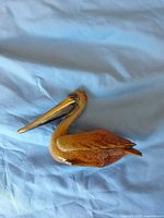 Left side view of glazed ceramic pelican figurine