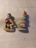 Both figurines front view on table cloth