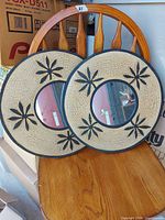Front view of both mirrors showing crackle beige frames with black leaf design and central mirrors