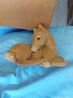 Full view of reclining foal figurine