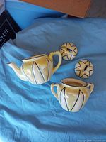 Teapot, sugar bowl, and both lids displayed
